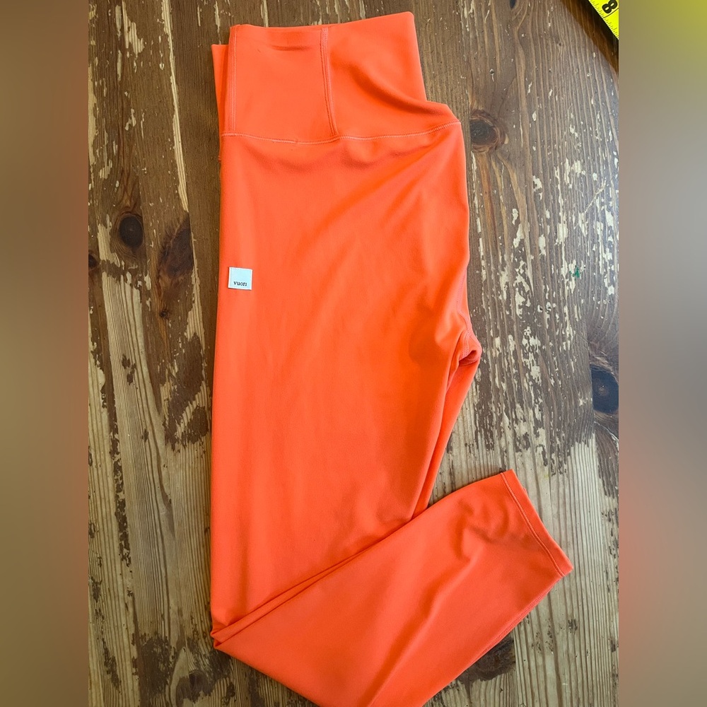 Vuori orange leggings. No size tag. Measurements in photos